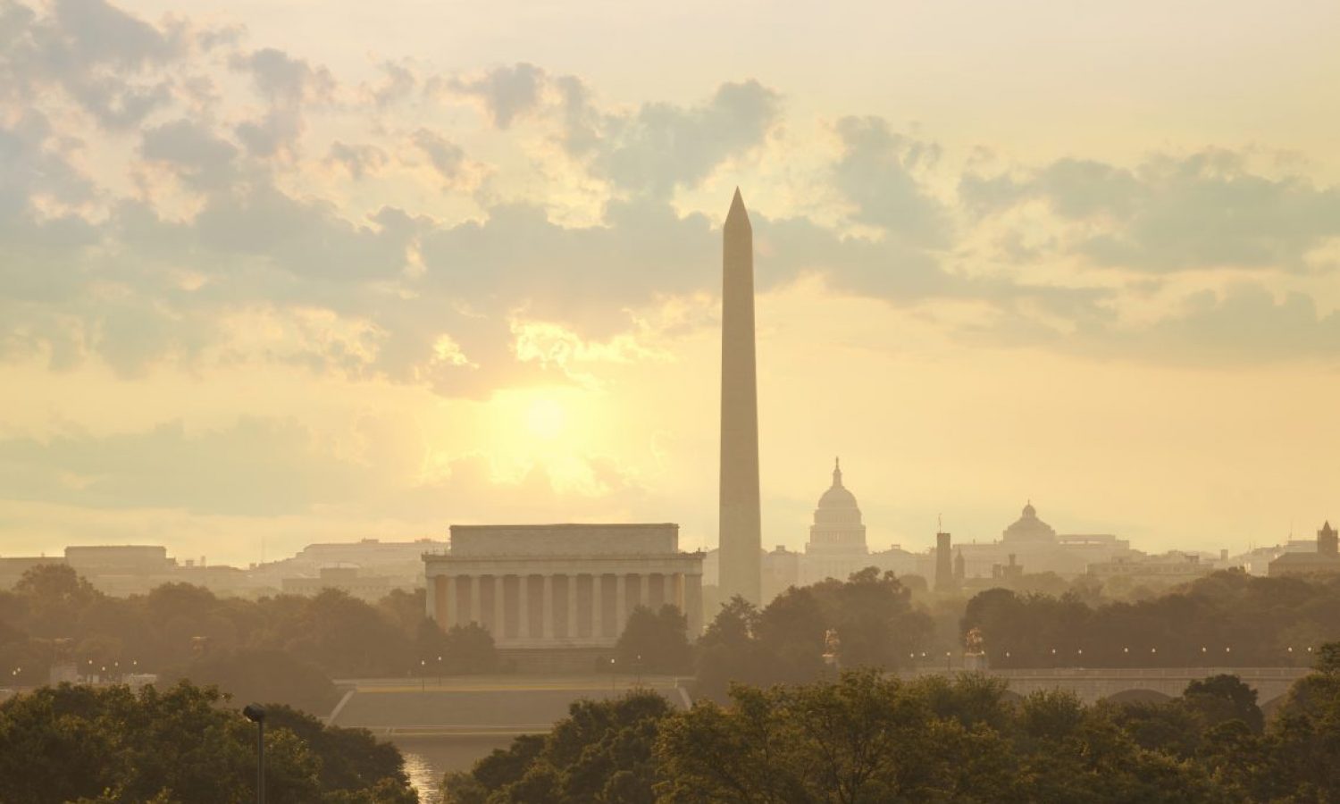 Washington DC skyline with sun and clouds in the morning